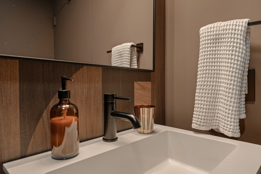 An elevated Palm Springs bathroom remodel blending natural stone, warm wood cabinetry, and spa-inspired lighting. Shot for an architectural designer to showcase luxury renovation details.